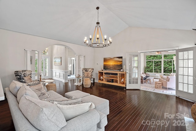 living area featuring high vaulted ceiling, decorative columns, a wainscoted wall, arched walkways, and hardwood / wood-style flooring
