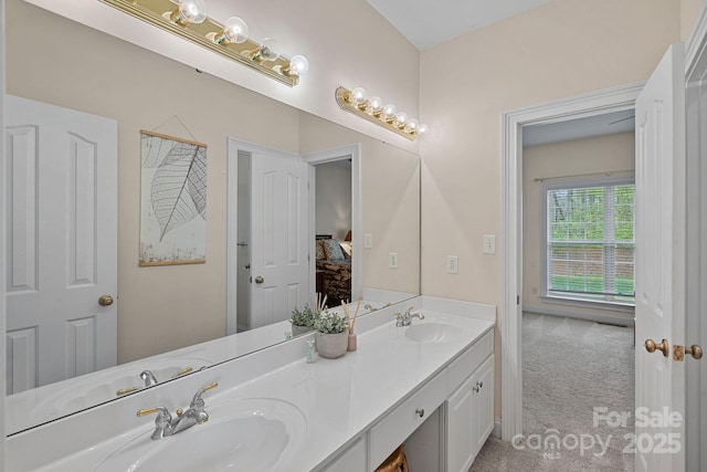 ensuite bathroom with double vanity, ensuite bathroom, and a sink