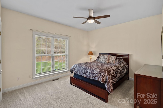carpeted bedroom featuring baseboards, visible vents, and ceiling fan
