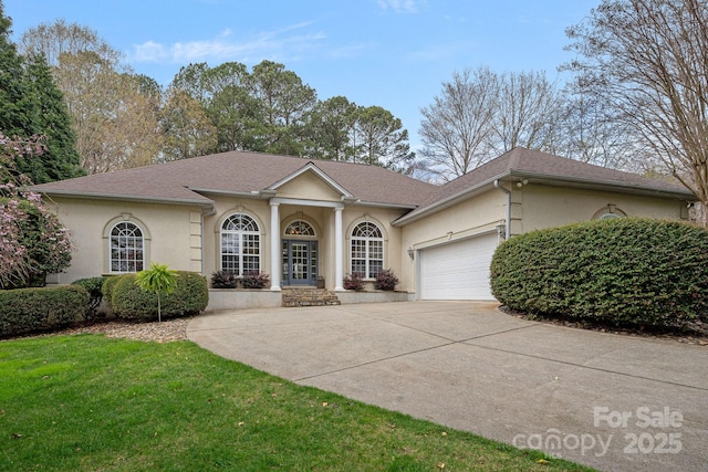 view of front facade featuring concrete driveway, roof with shingles, a front yard, stucco siding, and a garage