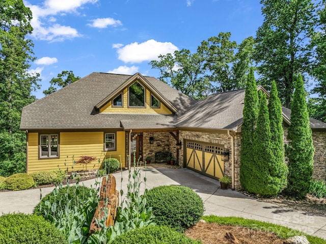 556 High Pines Loop, Lake Lure, NC 28746 - view of front of house featuring concrete driveway, an attached garage, and a shingled roof