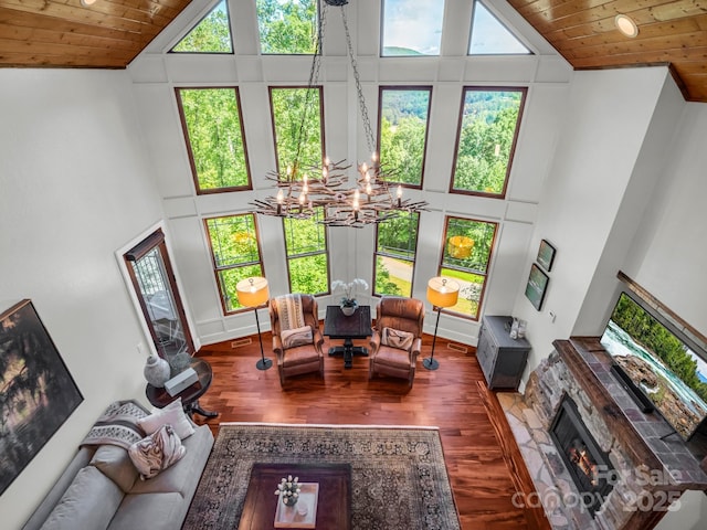 556 High Pines Loop, Lake Lure, NC 28746 - living area featuring high vaulted ceiling, a chandelier, wooden ceiling, wood finished floors, and a stone fireplace