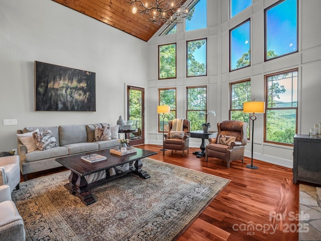 556 High Pines Loop, Lake Lure, NC 28746 - living room with high vaulted ceiling, a chandelier, healthy amount of natural light, wood finished floors, and wooden ceiling