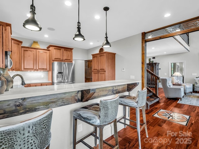 556 High Pines Loop, Lake Lure, NC 28746 - kitchen with appliances with stainless steel finishes, dark wood-style floors, decorative light fixtures, a peninsula, and a kitchen breakfast bar