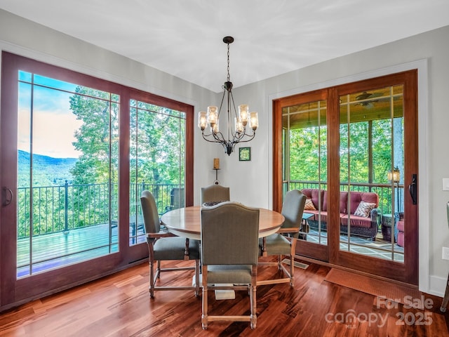 556 High Pines Loop, Lake Lure, NC 28746 - dining room featuring a chandelier, plenty of natural light, and wood finished floors