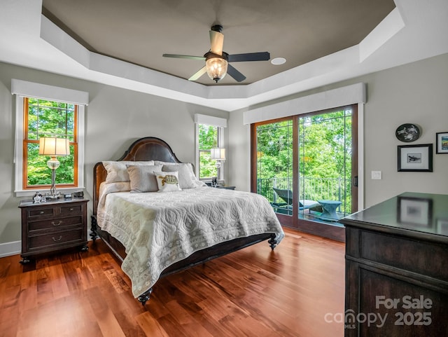 556 High Pines Loop, Lake Lure, NC 28746 - bedroom featuring a tray ceiling, access to outside, multiple windows, and dark wood finished floors