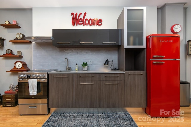 107 Cherry St, Black Mountain, NC 28711 - kitchen with stainless steel electric range oven, modern cabinets, a sink, refrigerator, and light wood-style flooring