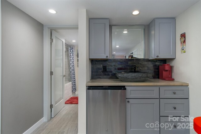 107 Cherry St, Black Mountain, NC 28711 - bar with baseboards, recessed lighting, fridge, backsplash, and light wood-style flooring