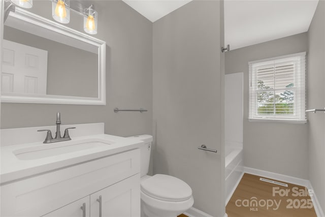 full bath with vanity, baseboards, toilet, visible vents, and wood finished floors