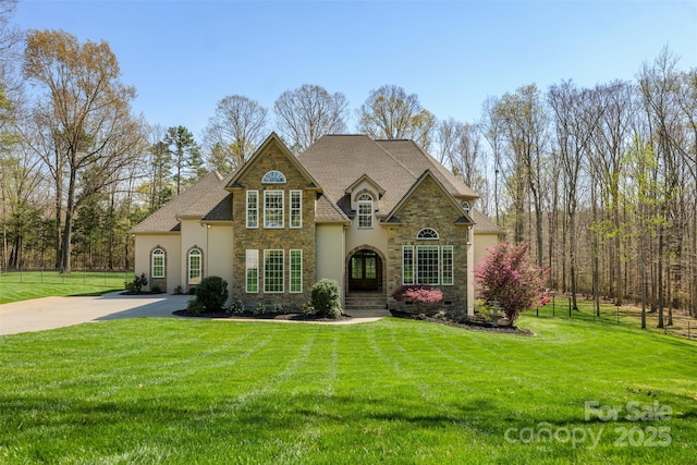 2017 Colorado Ct, Lancaster, SC 29720 - french country home with stone siding, stucco siding, a front lawn, and driveway