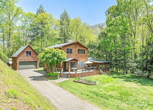 1192 Rockdale Rd, Whittier, NC 28789 - view of front facade with a detached garage, a front yard, a view of trees, an outbuilding, and a chimney