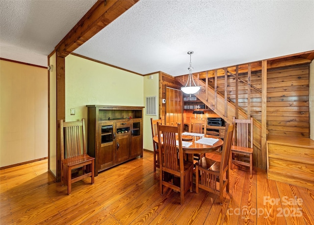 1192 Rockdale Rd, Whittier, NC 28789 - dining area with light wood-style floors, stairs, a textured ceiling, and visible vents