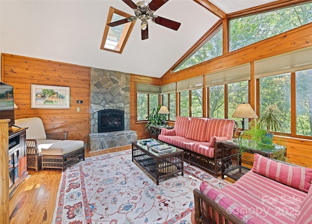 1192 Rockdale Rd, Whittier, NC 28789 - living area with a ceiling fan, wood walls, a healthy amount of sunlight, and wood finished floors