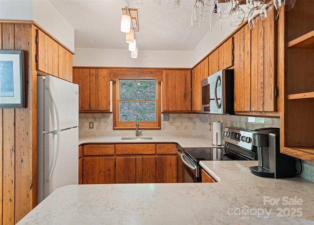 1192 Rockdale Rd, Whittier, NC 28789 - kitchen featuring light countertops, a sink, decorative backsplash, and stainless steel appliances