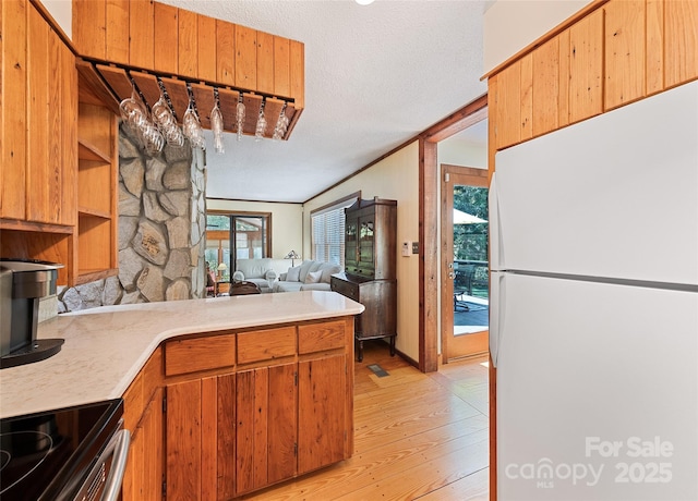 1192 Rockdale Rd, Whittier, NC 28789 - kitchen with light countertops, freestanding refrigerator, light wood-type flooring, and a textured ceiling