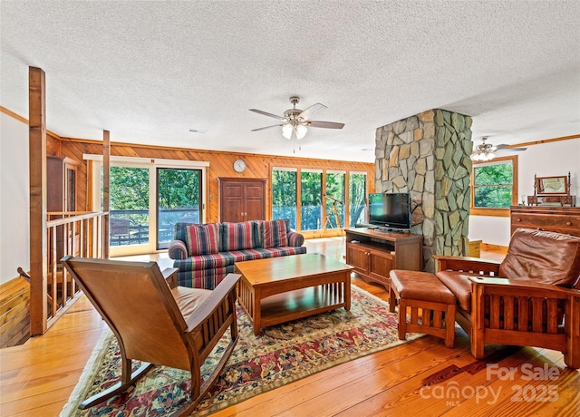1192 Rockdale Rd, Whittier, NC 28789 - living area with a ceiling fan, wood walls, a wealth of natural light, and light wood-type flooring