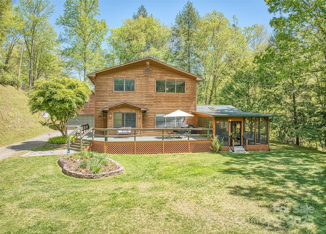 1192 Rockdale Rd, Whittier, NC 28789 - rear view of property with a sunroom, a wooden deck, and a yard