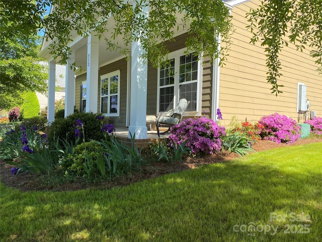 view of home's exterior featuring a yard and a porch