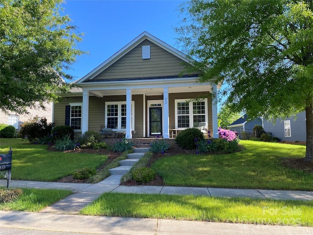 view of front of property featuring covered porch and a front yard