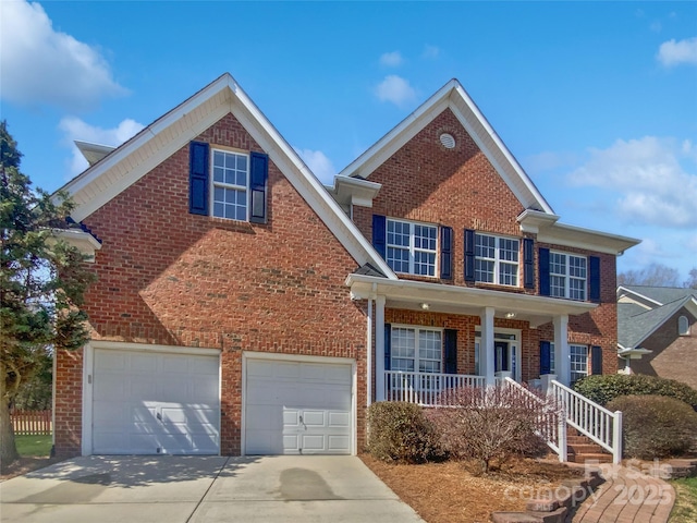 traditional-style home featuring brick siding, a garage, concrete driveway, and a porch