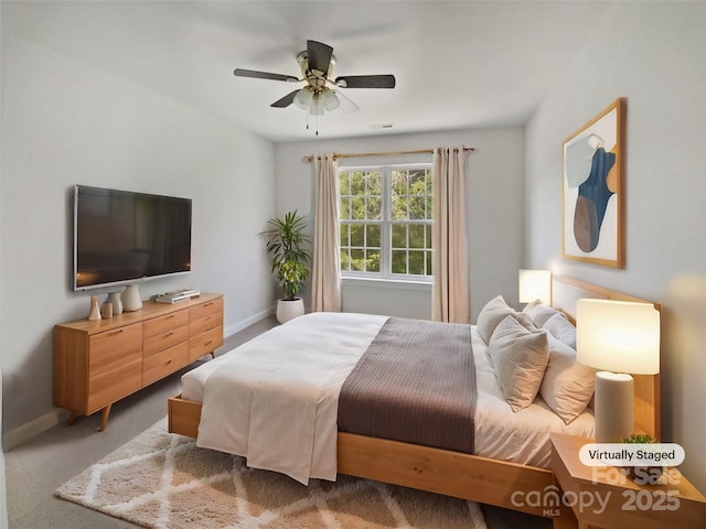 carpeted bedroom with baseboards and ceiling fan