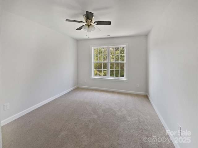 empty room with baseboards, carpet flooring, and ceiling fan