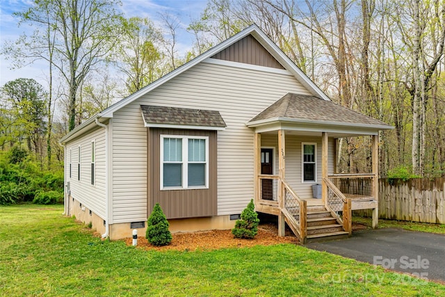 bungalow featuring crawl space, a front lawn, fence, a porch, and roof with shingles
