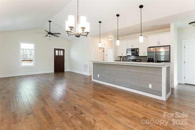 220 Mount Allen Heights, Black Mountain, NC 28711 - kitchen with stainless steel appliances, a chandelier, white cabinets, light countertops, and decorative backsplash
