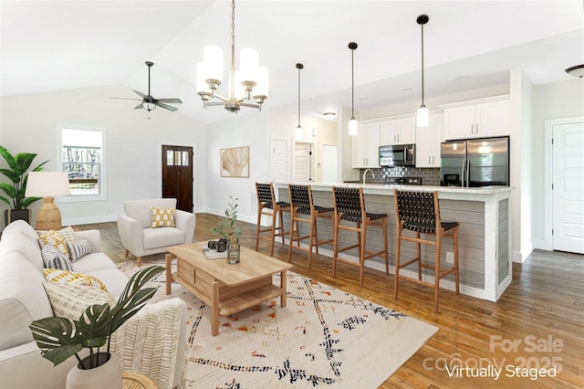 220 Mount Allen Heights, Black Mountain, NC 28711 - living room featuring wood finished floors, a chandelier, lofted ceiling, and a ceiling fan