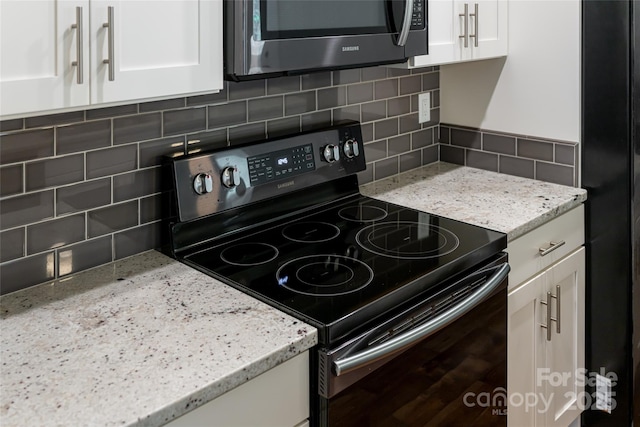 220 Mount Allen Heights, Black Mountain, NC 28711 - kitchen with black appliances, decorative backsplash, white cabinetry, and light stone counters
