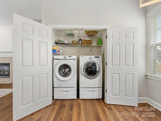 4148 Cedar Point Ave, Matthews, NC 28104 - laundry area with washing machine and clothes dryer, wood finished floors, and a fireplace