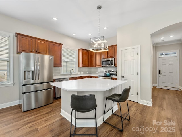 4148 Cedar Point Ave, Matthews, NC 28104 - kitchen featuring stainless steel appliances, tasteful backsplash, light countertops, wood finished floors, and recessed lighting