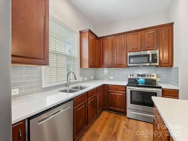 4148 Cedar Point Ave, Matthews, NC 28104 - kitchen with stainless steel appliances, light wood-style floors, and light countertops