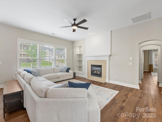 4148 Cedar Point Ave, Matthews, NC 28104 - living room with ceiling fan, arched walkways, wood finished floors, and built in features