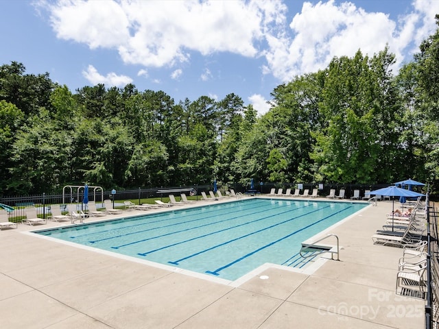 4148 Cedar Point Ave, Matthews, NC 28104 - community pool featuring a patio area and view of scattered trees