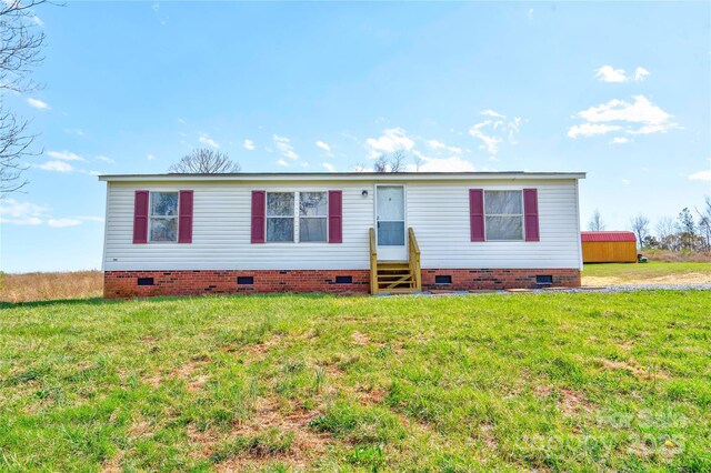 manufactured / mobile home featuring crawl space, a front lawn, and entry steps