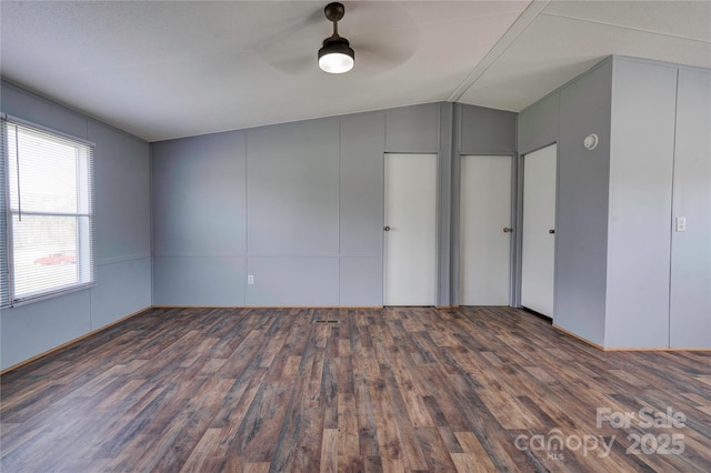 unfurnished bedroom with a ceiling fan, vaulted ceiling, and wood finished floors