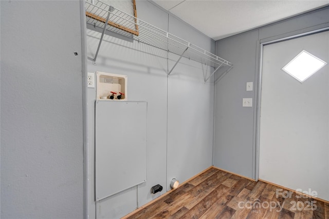 laundry area featuring washer hookup, wood finished floors, and laundry area