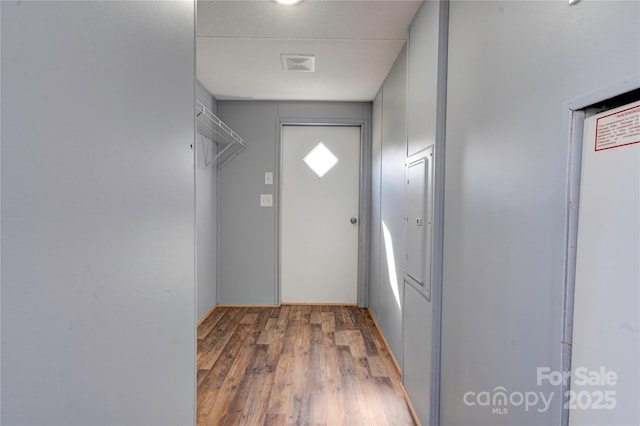 doorway to outside featuring visible vents and wood finished floors