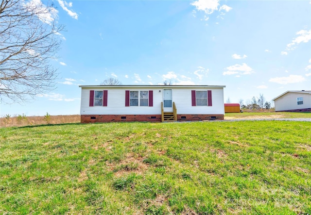 manufactured / mobile home featuring crawl space, a front yard, and entry steps