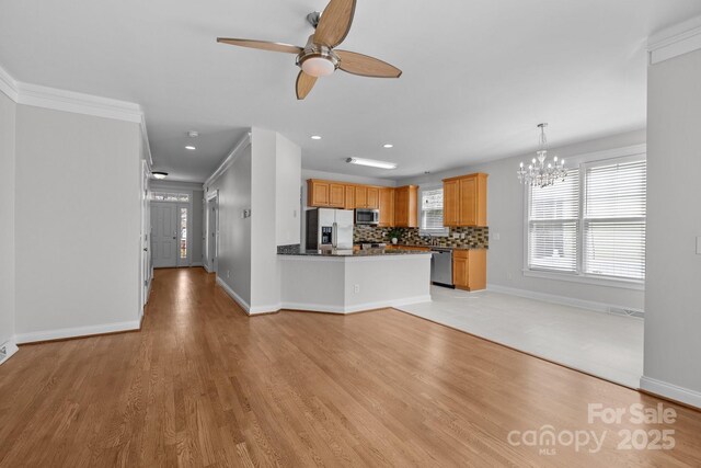9652 Alma Blount Blvd, Charlotte, NC 28277 - unfurnished living room featuring ceiling fan with notable chandelier, light wood-type flooring, baseboards, ornamental molding, and recessed lighting