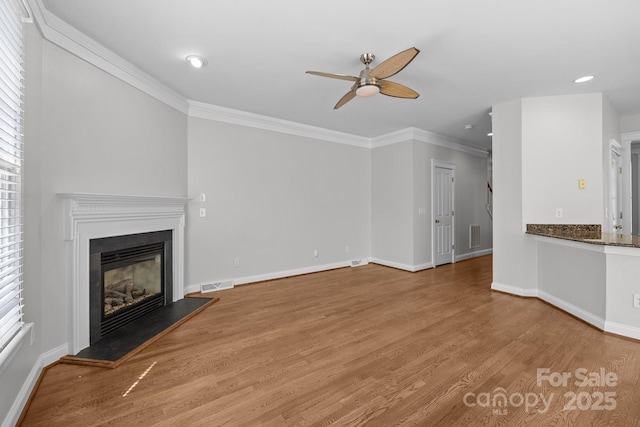 9652 Alma Blount Blvd, Charlotte, NC 28277 - unfurnished living room featuring baseboards, visible vents, a glass covered fireplace, light wood-style floors, and ceiling fan