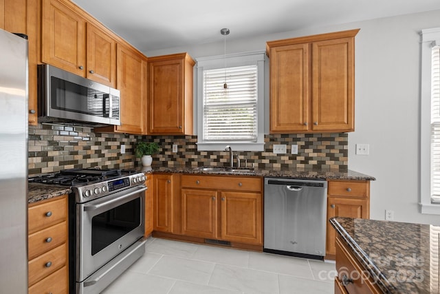 9652 Alma Blount Blvd, Charlotte, NC 28277 - kitchen with brown cabinets, appliances with stainless steel finishes, decorative backsplash, and a sink