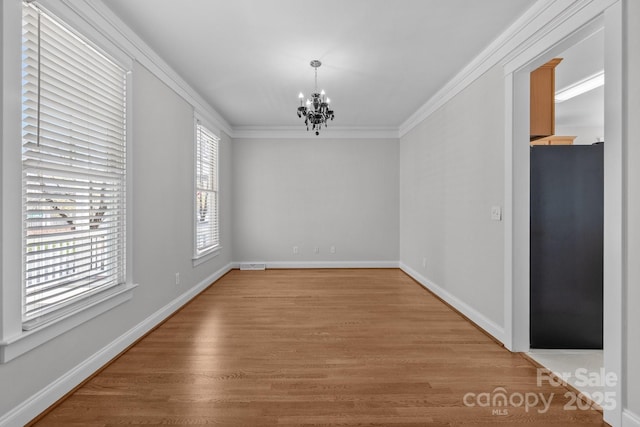 9652 Alma Blount Blvd, Charlotte, NC 28277 - unfurnished dining area featuring light wood-style flooring, baseboards, a notable chandelier, and crown molding
