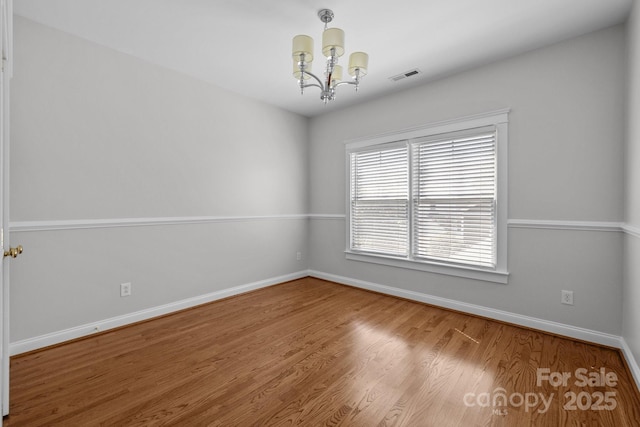 9652 Alma Blount Blvd, Charlotte, NC 28277 - spare room featuring baseboards, wood finished floors, visible vents, and a chandelier