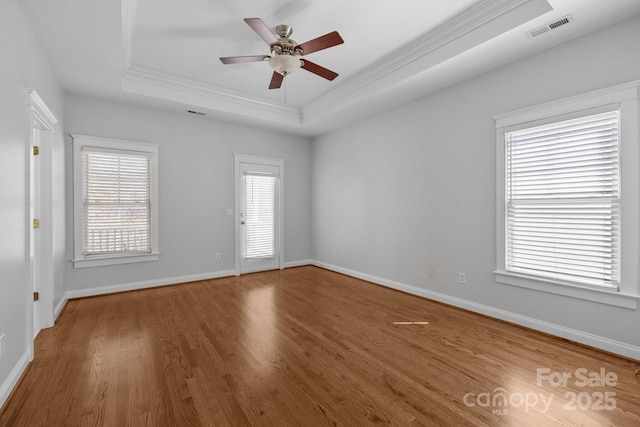 9652 Alma Blount Blvd, Charlotte, NC 28277 - spare room featuring a raised ceiling, wood finished floors, visible vents, a ceiling fan, and ornamental molding
