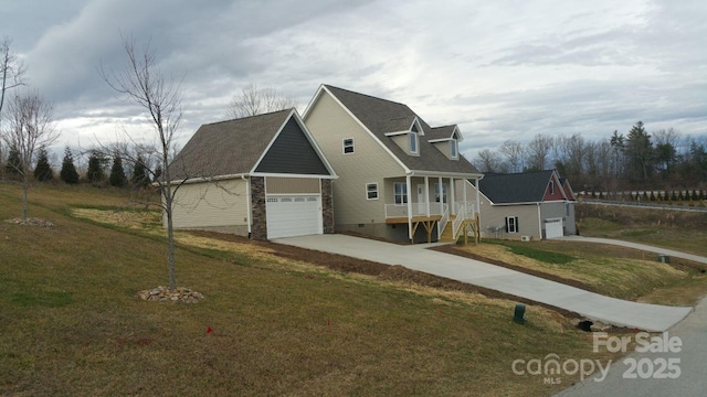 119 Tryon View Dr, Flat Rock, NC 28731 - view of front of house featuring driveway, a front lawn, and an attached garage