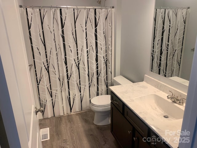 119 Tryon View Dr, Flat Rock, NC 28731 - bathroom with wood finished floors, toilet, vanity, and shower / tub combo with curtain