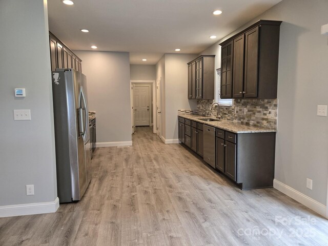 119 Tryon View Dr, Flat Rock, NC 28731 - kitchen featuring stainless steel appliances, dark brown cabinets, light wood finished floors, light stone countertops, and recessed lighting