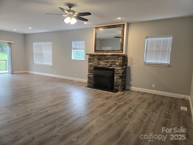 119 Tryon View Dr, Flat Rock, NC 28731 - unfurnished living room with a stone fireplace, dark wood-style floors, plenty of natural light, and recessed lighting